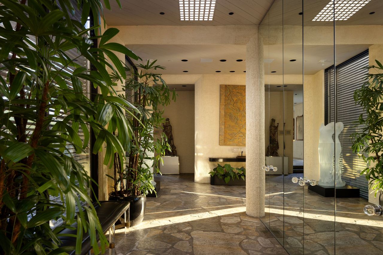 Main residence gallery-like interior with stone floors and sculptural entry