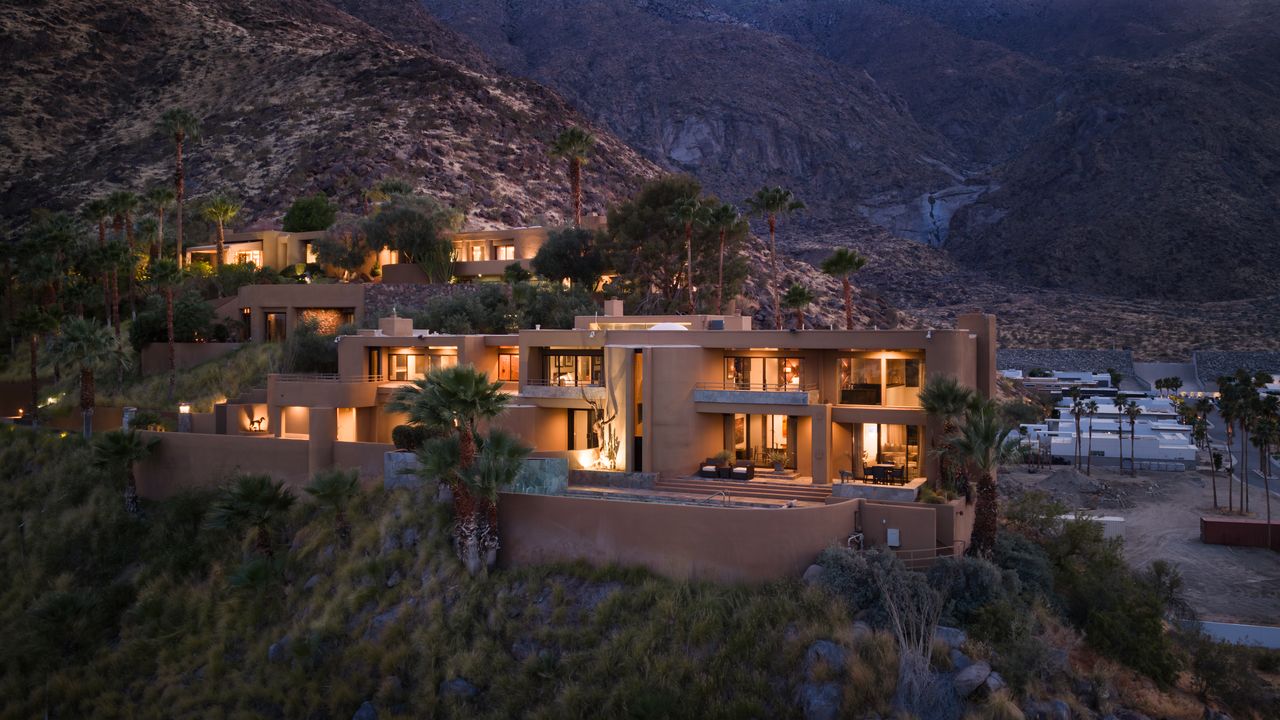 Estate compound at dusk against the mountainside