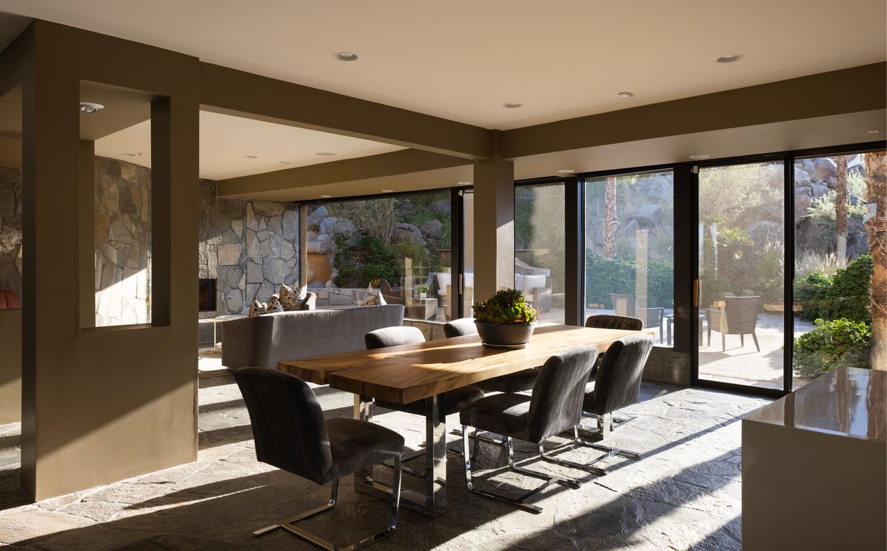 Dining area with live-edge table and floor-to-ceiling glass