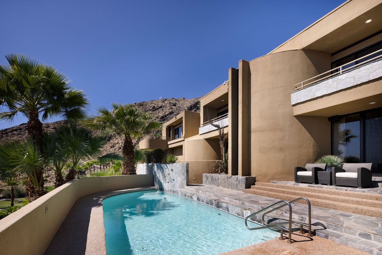 Private pool terrace tucked against the mountainside