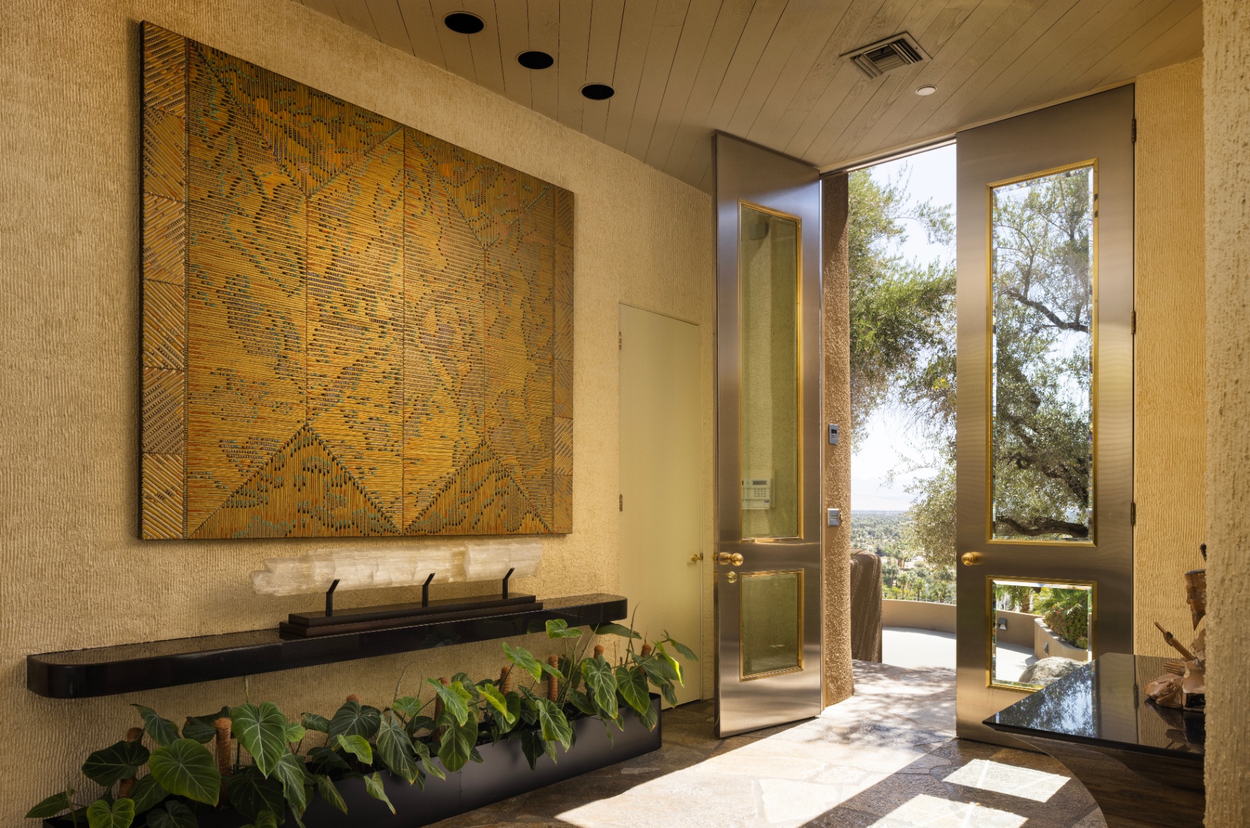 Main residence entry with tall bronze doors and artwork